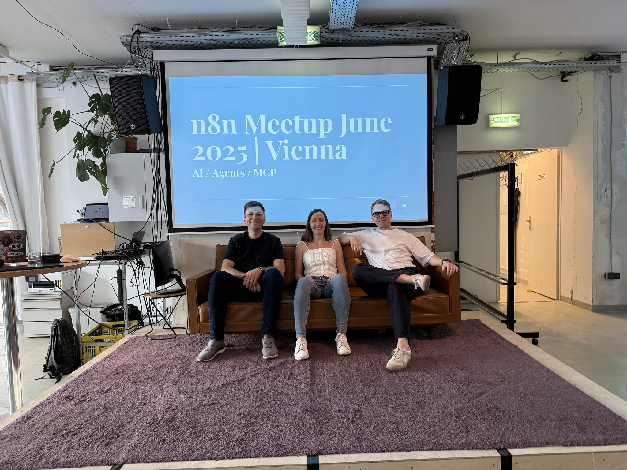 Photo of the n8n Vienna meetup speakers, Beniamin Hutyra, Nadia Privalikhina, and Cristian Livadaru